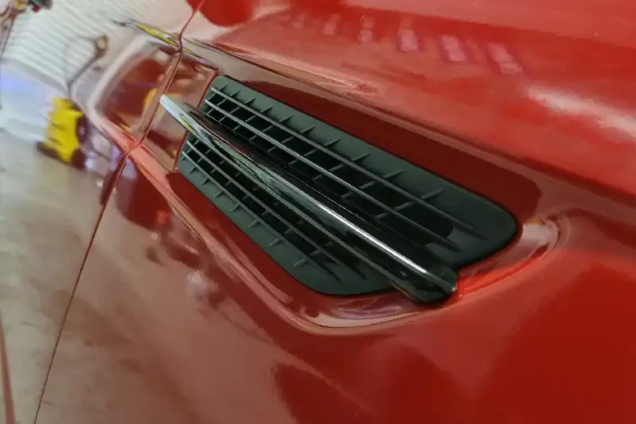 Close-up detail of Mercedes colour change wrap around side vent finished in gloss red at Wrap Your Car Kidderminster