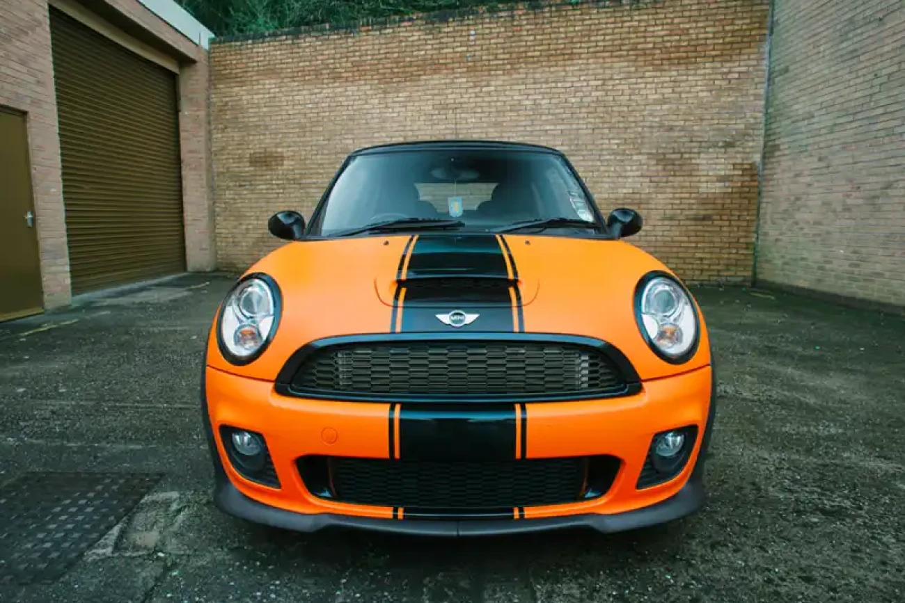Front view of Mini Cooper John Cooper Works with matte orange colour change wrap at Wrap Your Car Kidderminster