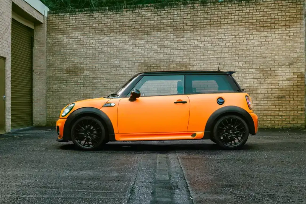 Side profile of Mini Cooper John Cooper Works with matte orange colour change wrap at Wrap Your Car Kidderminster
