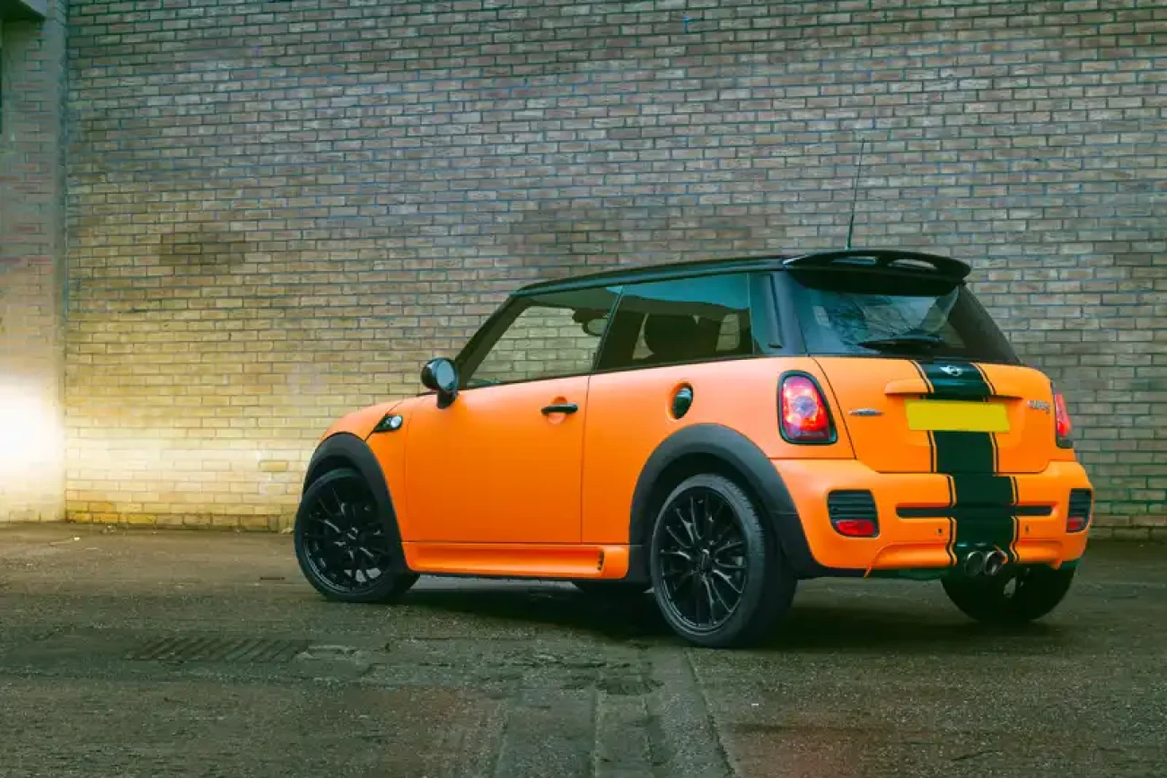 Rear three-quarter view of Mini Cooper John Cooper Works with matte orange colour change wrap at Wrap Your Car Kidderminster